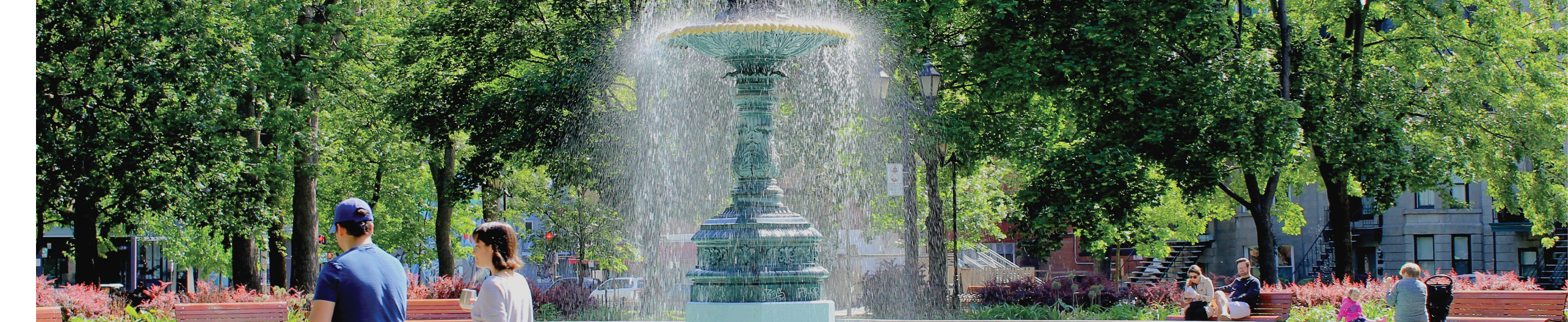 Montreal, Quebec   Canada - June 16 2019: Square Saint Louis in Plateau Mont Royal neighborhood known as Little France,with beautiful European lifestyle  Fountain among green leaves on hot summer day 